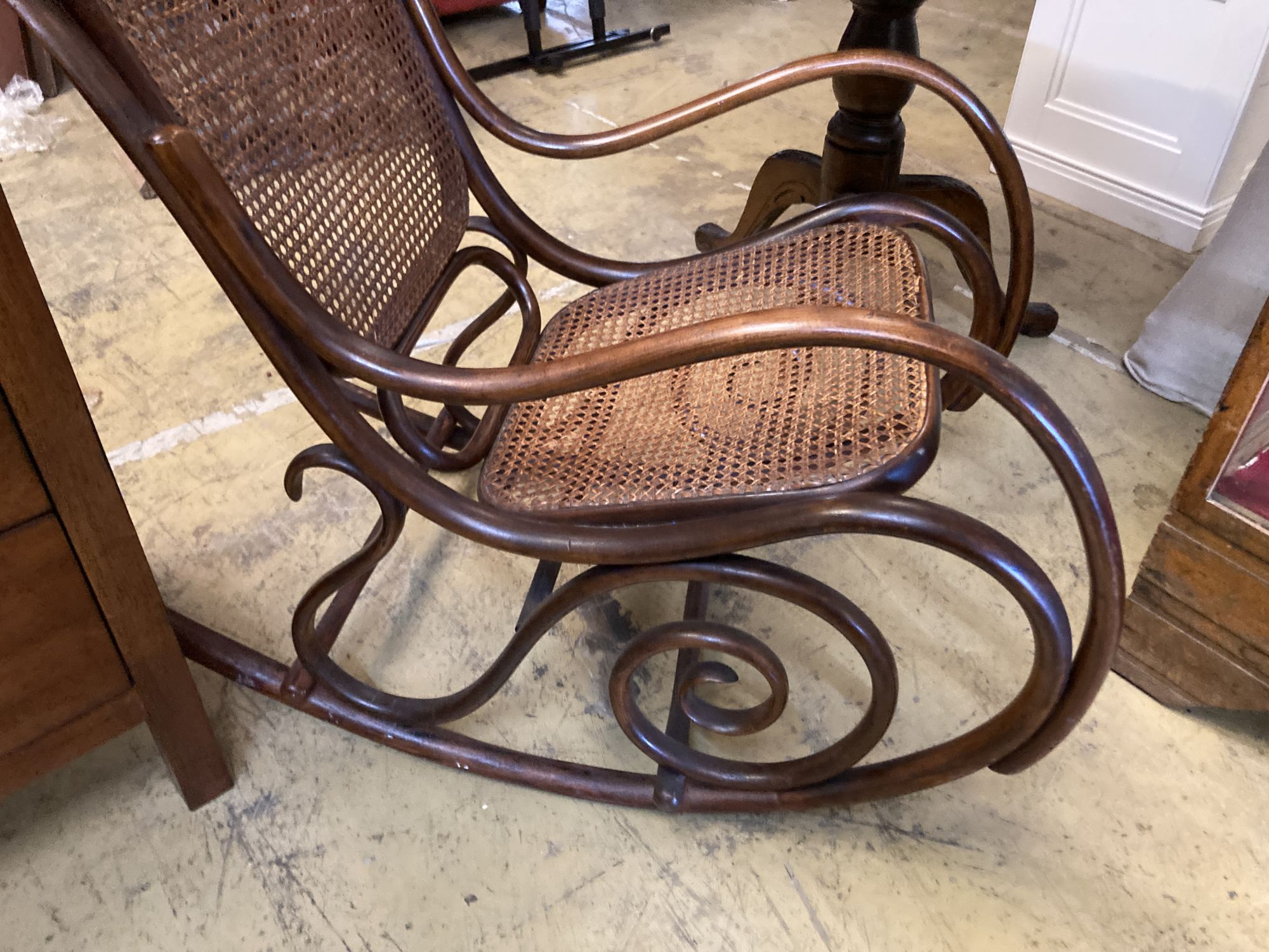 An early 20th century Thonet style caned bentwood rocking chair